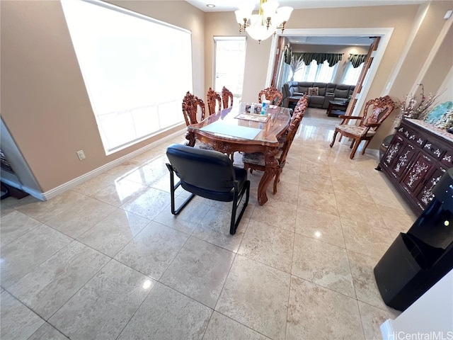 tiled dining room featuring a chandelier