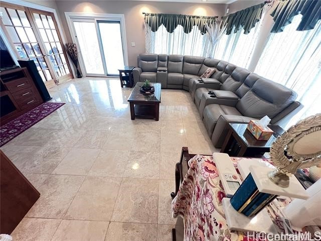 living room featuring french doors and light tile patterned flooring