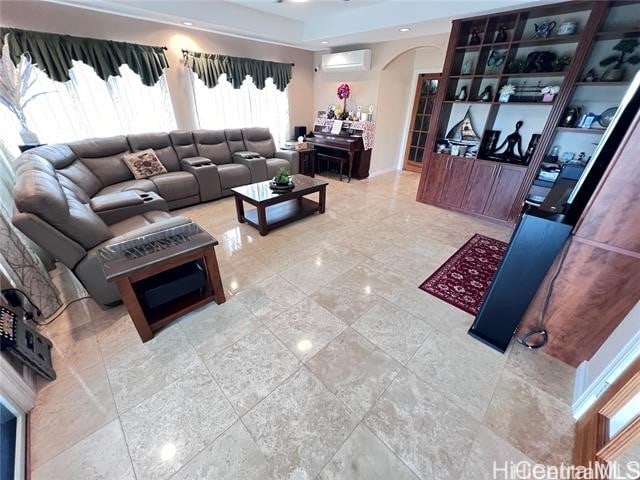 living room featuring an AC wall unit