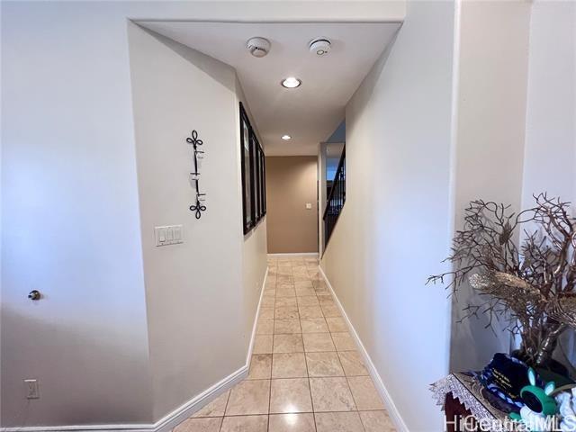 hall featuring light tile patterned flooring