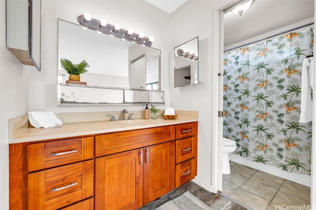 bathroom with vanity, curtained shower, and toilet