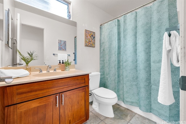 bathroom featuring tile patterned floors, vanity, and toilet