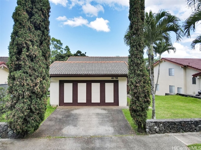 view of front of home with a garage and a front lawn