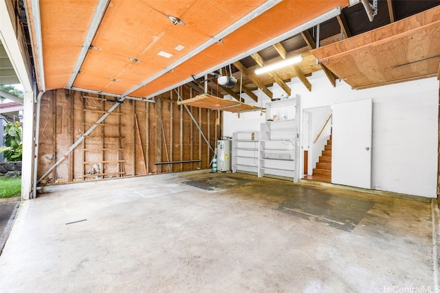 garage featuring a garage door opener and electric water heater