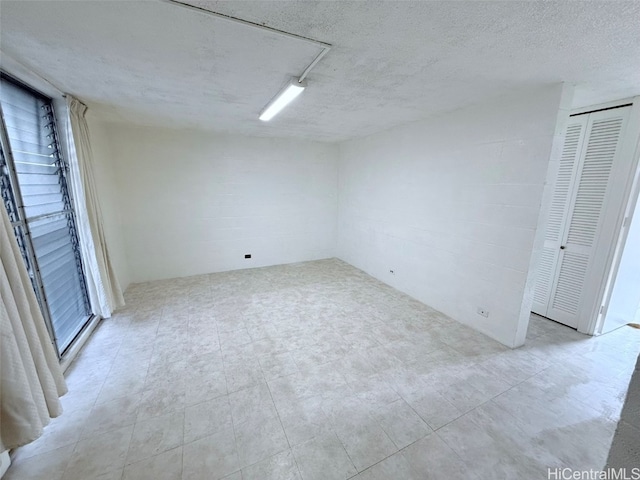 spare room featuring a textured ceiling