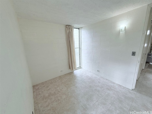 empty room featuring a textured ceiling