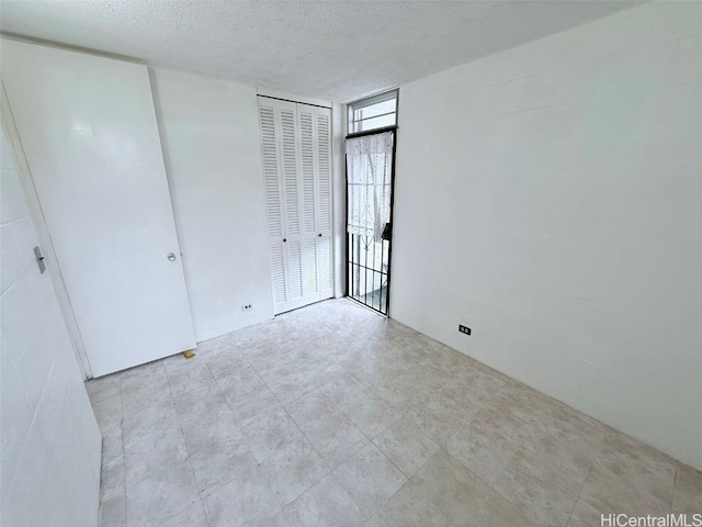 unfurnished bedroom with a textured ceiling