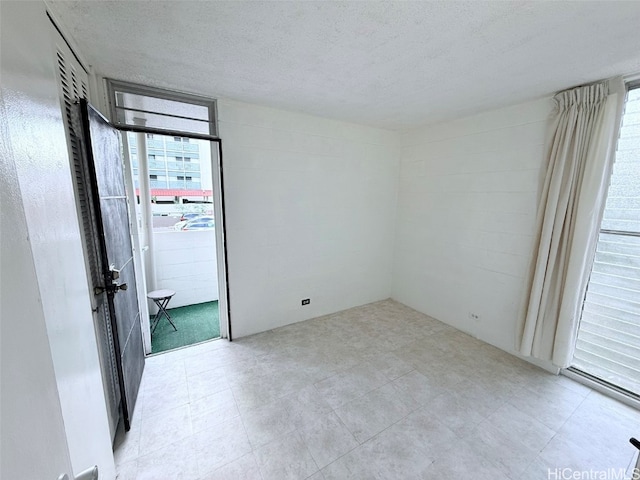 spare room featuring a textured ceiling