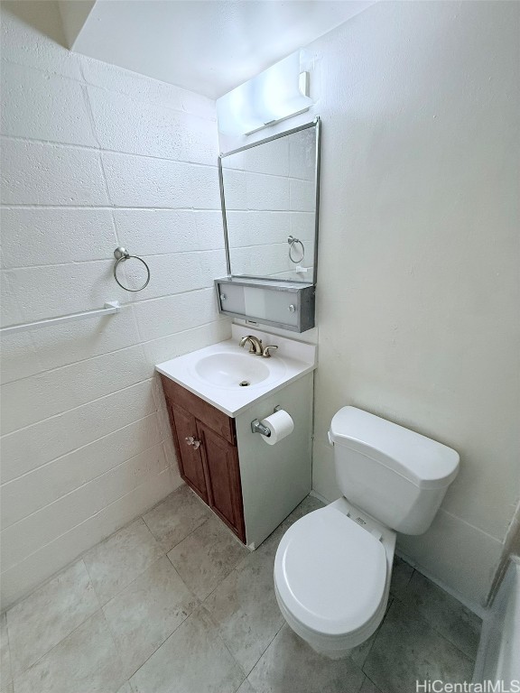 bathroom with vanity, toilet, and tile patterned floors