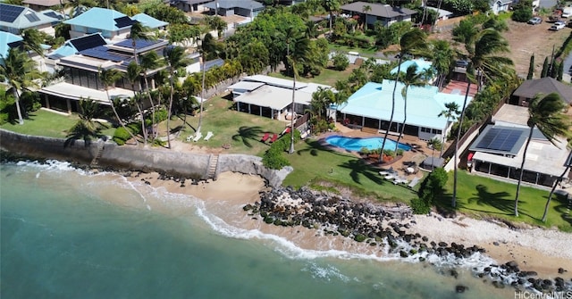 birds eye view of property featuring a water view and a beach view