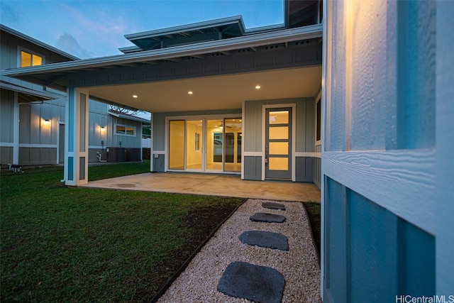 property entrance featuring a yard and a patio