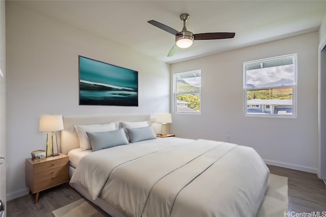 bedroom featuring ceiling fan and dark hardwood / wood-style flooring