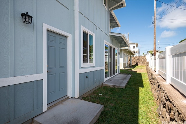 property entrance with a yard