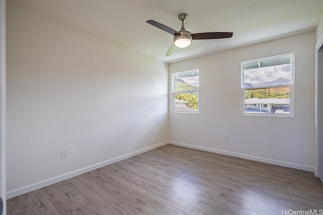 spare room featuring hardwood / wood-style flooring and ceiling fan