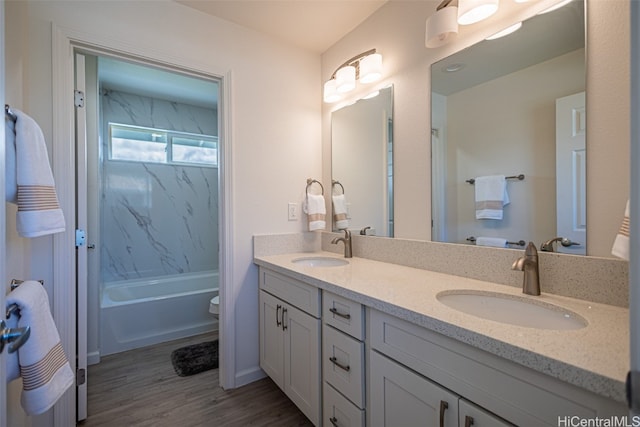 full bathroom featuring vanity, hardwood / wood-style flooring, toilet, and tub / shower combination