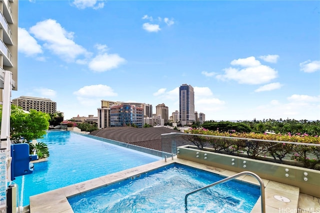 view of swimming pool with a community hot tub