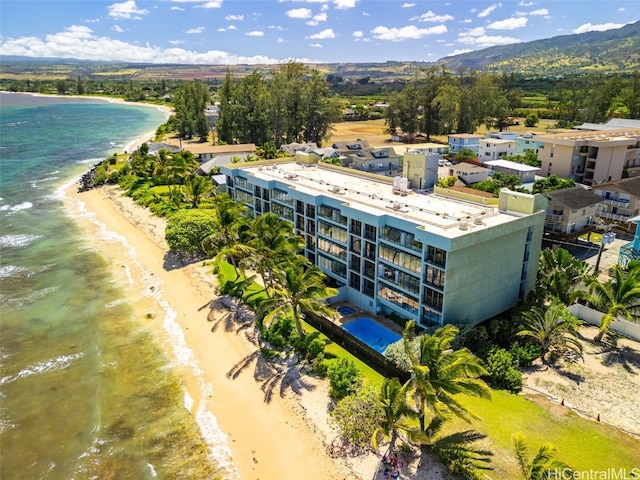 drone / aerial view with a water view and a beach view