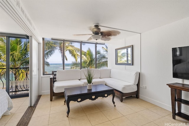 sunroom / solarium featuring a water view and ceiling fan