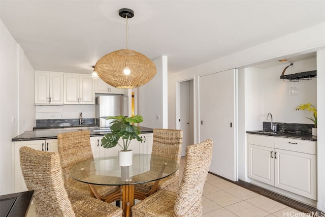 dining area with light tile patterned floors and sink