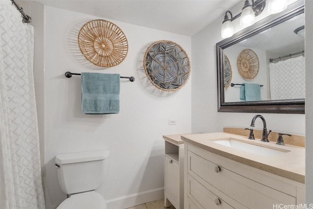 bathroom featuring tile patterned floors, vanity, and toilet