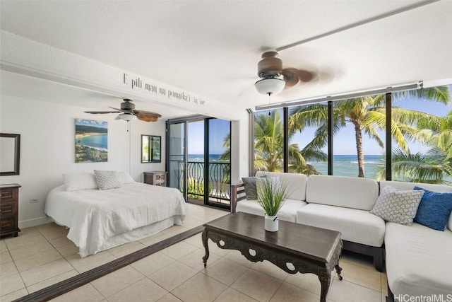 tiled bedroom featuring access to outside, ceiling fan, and a water view