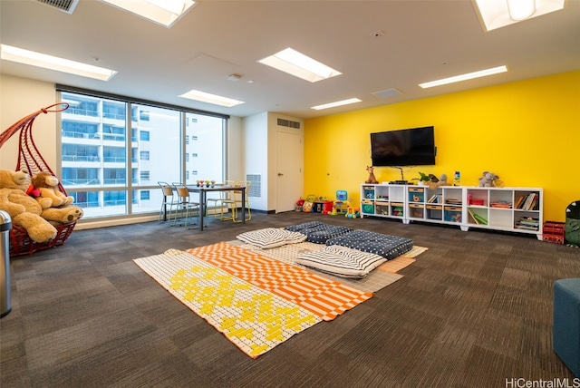 rec room with expansive windows and carpet floors