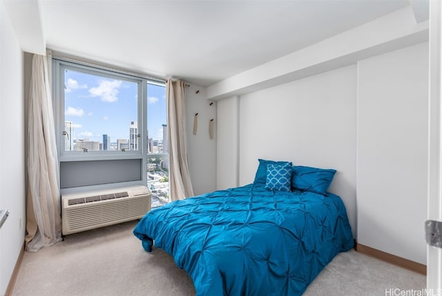 bedroom with a wall mounted AC and carpet