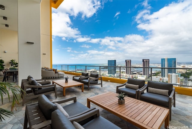 view of patio with a balcony, a water view, and an outdoor hangout area