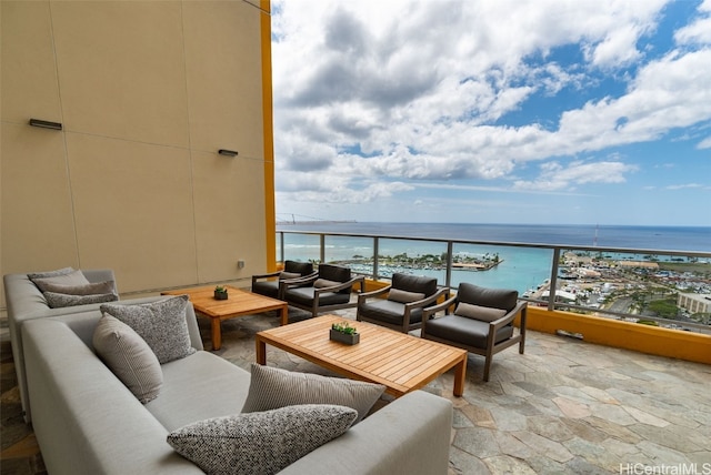 balcony featuring a water view and outdoor lounge area