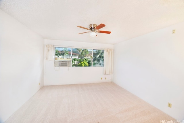 unfurnished room featuring a textured ceiling, cooling unit, carpet floors, and ceiling fan