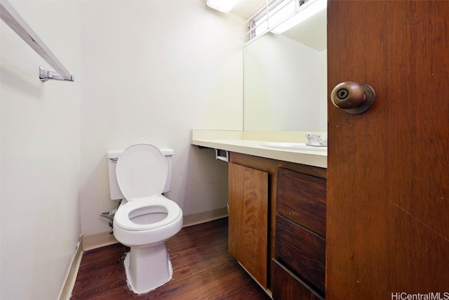 bathroom with vanity, toilet, and wood-type flooring