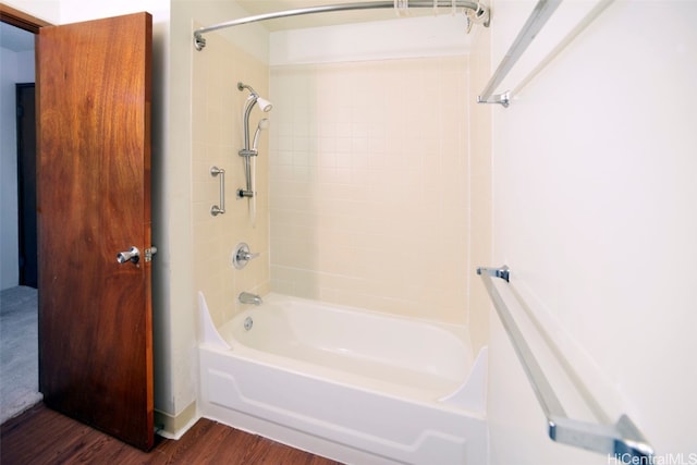 bathroom with tiled shower / bath and hardwood / wood-style flooring