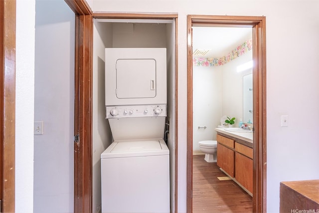 350 Aoloa St Unit A236, Kailua, HI 96734 - laundry area featuring stacked washing machine and dryer and light wood finished floors