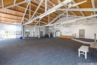 interior space featuring carpet floors and high vaulted ceiling