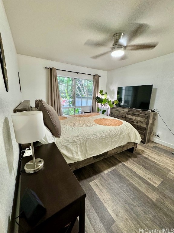 bedroom with wood-type flooring and ceiling fan