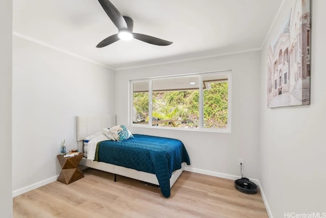 bedroom with crown molding, wood-type flooring, and ceiling fan