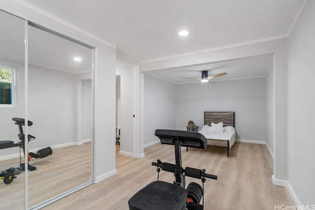 exercise area with crown molding, light wood-type flooring, and ceiling fan