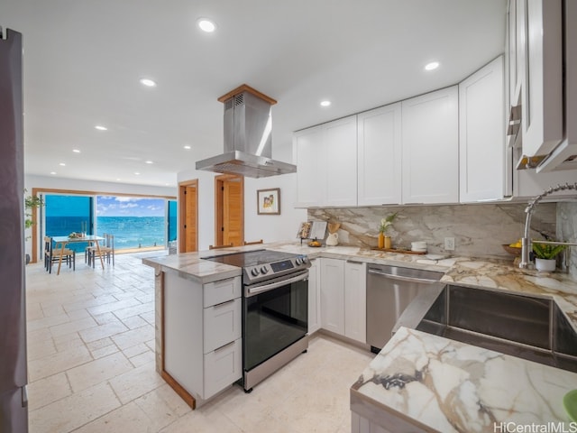 kitchen featuring appliances with stainless steel finishes, backsplash, kitchen peninsula, white cabinetry, and extractor fan