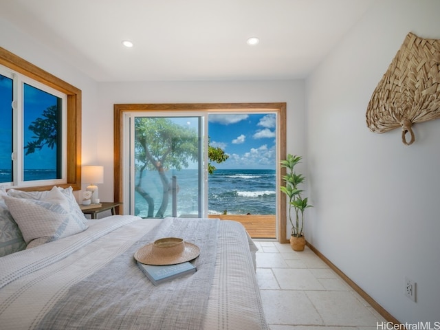 bedroom with access to exterior and a water view