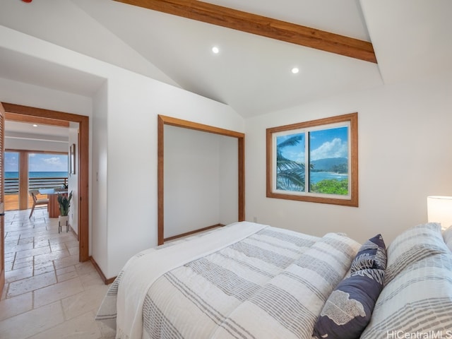 bedroom with a closet and lofted ceiling with beams