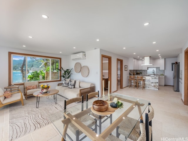 living room featuring sink, light tile patterned flooring, and a wall mounted air conditioner