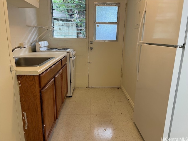 kitchen with sink and white appliances