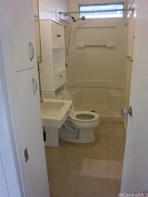 bathroom with toilet, a shower, and tile patterned floors