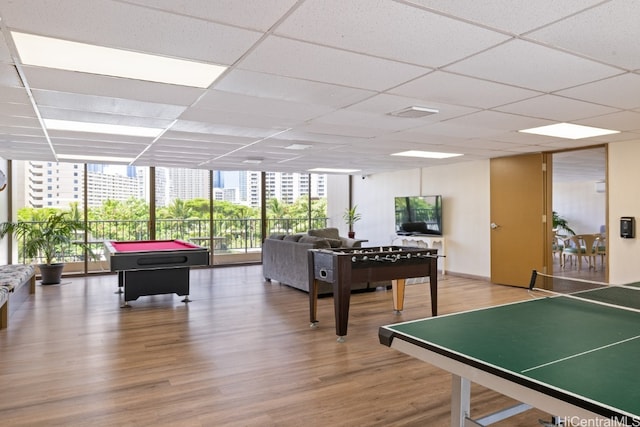 rec room with floor to ceiling windows, a drop ceiling, pool table, and hardwood / wood-style floors