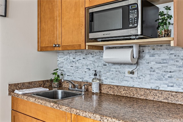 kitchen featuring tasteful backsplash and sink