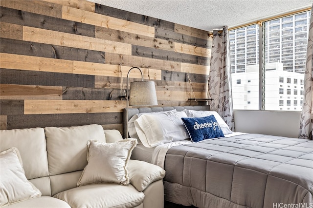 bedroom with a textured ceiling and wooden walls