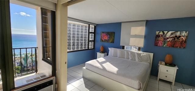 bedroom featuring a water view and light tile patterned floors