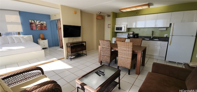 living room featuring light tile patterned flooring and sink