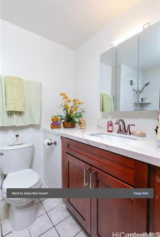 bathroom with tile patterned floors, vanity, and toilet