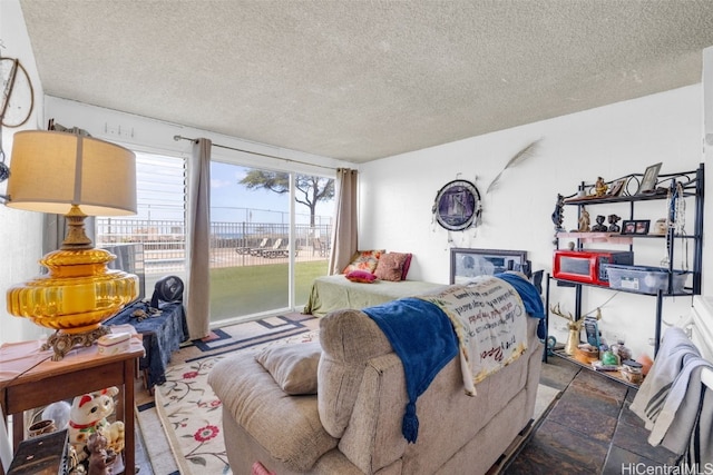 bedroom featuring a textured ceiling and access to exterior